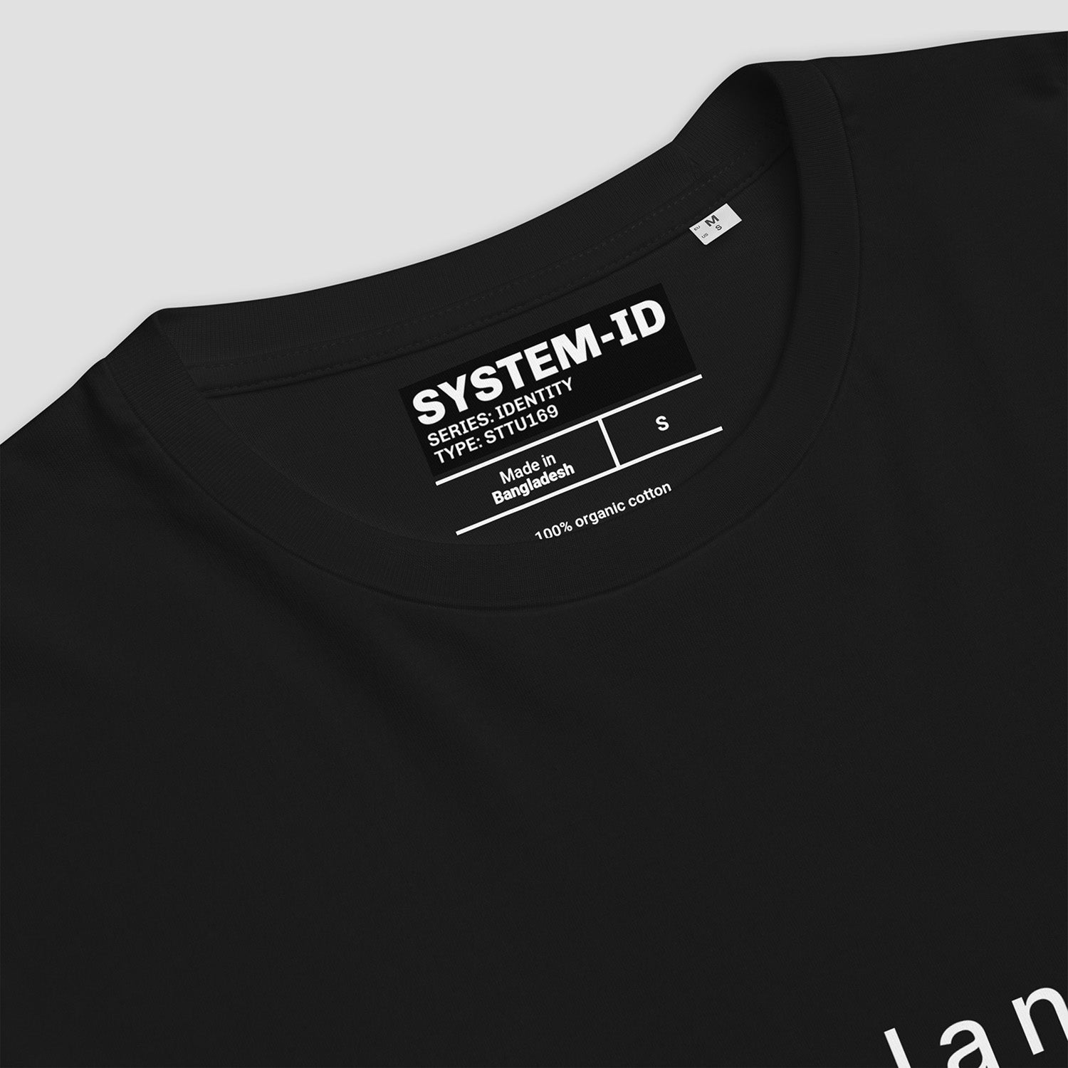 Black t-shirt with SYSTEM-ID label on a light gray background