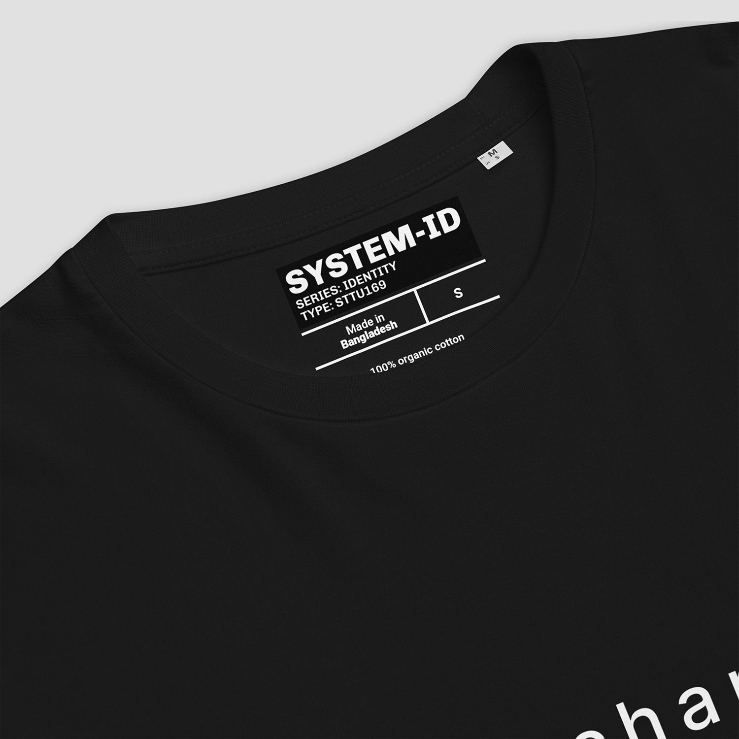 Black t-shirt with SYSTEM-ID label on a light gray background
