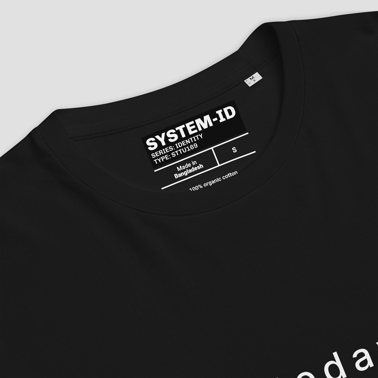 Black t-shirt with SYSTEM-ID label on a light gray background